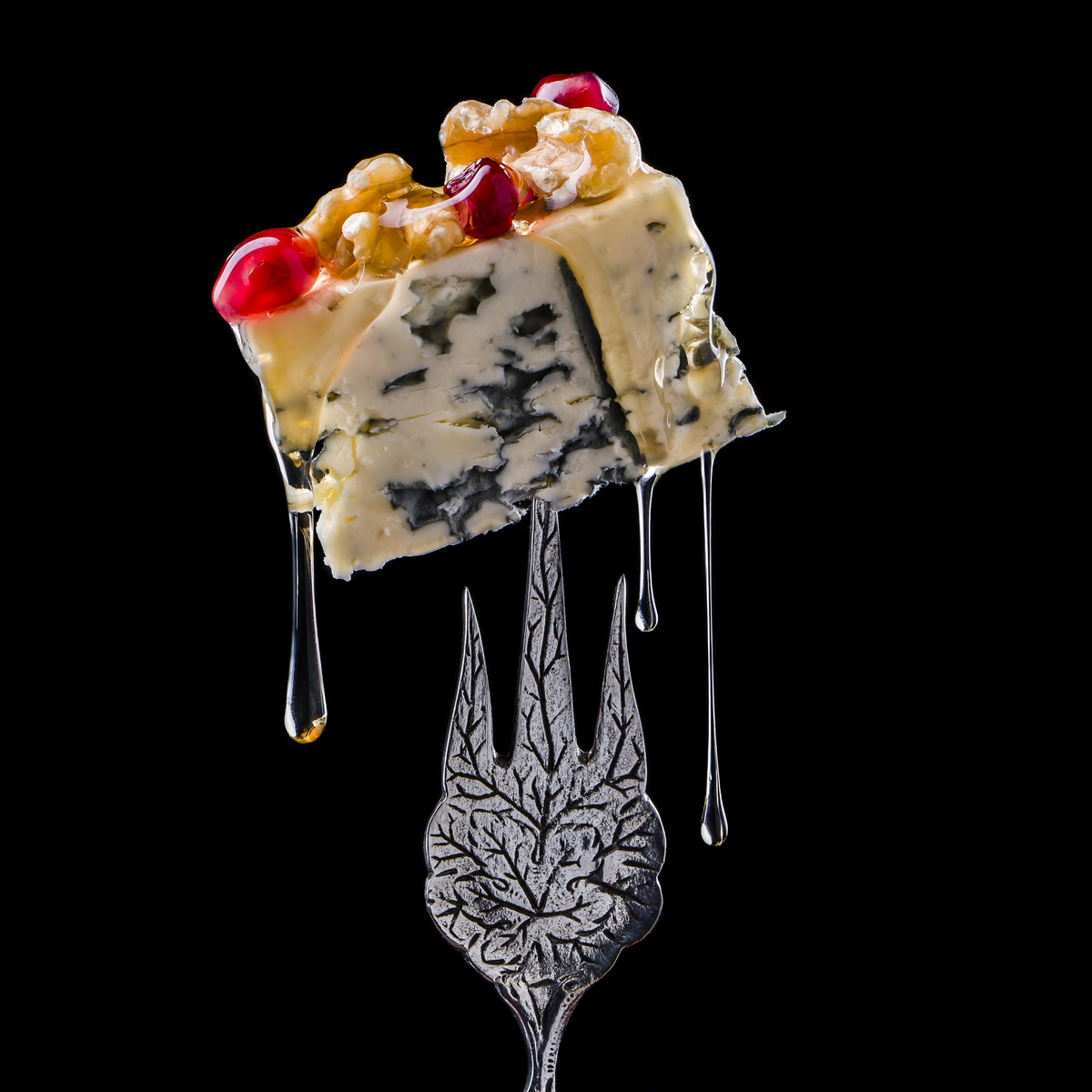 Foodfotografie kaas op vorkje met druipende honing door culinair master fotograaf